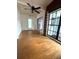 Living room featuring hardwood floors, fan and abundant natural light through a large window at 6615 Beamer Way, Orlando, FL 32807