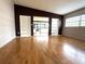 Open living room with hardwood floors and built-in shelving at 6615 Beamer Way, Orlando, FL 32807