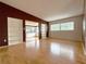 Spacious living room with hardwood floors and built in shelves, offering a versatile living space at 6615 Beamer Way, Orlando, FL 32807