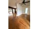 Open-concept living room with hardwood floors and access to other living spaces at 6615 Beamer Way, Orlando, FL 32807