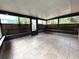 Enclosed sunroom featuring tile flooring, decorative ceiling, and large windows providing natural light and backyard views at 6615 Beamer Way, Orlando, FL 32807