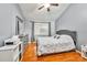 Comfortable bedroom with wood floors, a ceiling fan, a queen-sized bed, and plenty of natural light at 701 Saint Michael Ln, Altamonte Springs, FL 32714