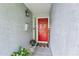 Inviting front entrance with a bright red door and decorative 'Home' sign at 701 Saint Michael Ln, Altamonte Springs, FL 32714