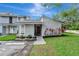 Charming townhome featuring a landscaped front yard and neutral gray exterior at 701 Saint Michael Ln, Altamonte Springs, FL 32714