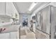 Well-lit kitchen with ample counter space, stainless steel refrigerator, and white cabinetry at 701 Saint Michael Ln, Altamonte Springs, FL 32714