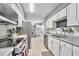 Bright kitchen with white cabinets, stainless steel appliances, and tiled backsplash at 701 Saint Michael Ln, Altamonte Springs, FL 32714