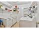 Efficient laundry room featuring a washer, dryer, storage cabinets, and shelving for organization at 701 Saint Michael Ln, Altamonte Springs, FL 32714