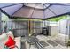 Outdoor patio area with comfortable seating, a fan, and a gazebo offering a relaxing retreat at 701 Saint Michael Ln, Altamonte Springs, FL 32714
