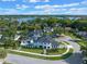 Aerial view of luxurious home on large lot featuring a private pool, lush landscaping, and lake views at 734 Terra Pl, Maitland, FL 32751