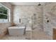 Stunning bathroom featuring a modern soaking tub and an expansive shower with designer tile and brass fixtures at 734 Terra Pl, Maitland, FL 32751