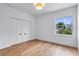 Minimalist bedroom featuring light wood floors, white walls, and a window, offering a bright and airy feel at 734 Terra Pl, Maitland, FL 32751