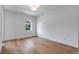 Bright empty bedroom features beautiful wood floors, fresh white paint and trim, and a lovely arched window at 734 Terra Pl, Maitland, FL 32751