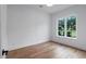 Light-filled bedroom offers serene views of the neighborhood and features hardwood floors at 734 Terra Pl, Maitland, FL 32751