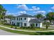 Stunning two-story home featuring manicured landscaping and modern architectural details under a sunny, partly cloudy sky at 734 Terra Pl, Maitland, FL 32751