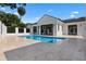Beautiful modern home with dark trim is situated around a sparkling pool and travertine patio at 734 Terra Pl, Maitland, FL 32751