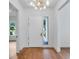 Bright foyer showcasing hardwood floors and an elegant chandelier, setting a welcoming tone for the home at 734 Terra Pl, Maitland, FL 32751