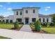 Beautiful two-story home featuring modern design, a well-manicured lawn, and a paved walkway leading to the entrance at 734 Terra Pl, Maitland, FL 32751