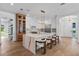 Bright kitchen boasts a large waterfall island with seating, stainless steel appliances, and custom cabinets at 734 Terra Pl, Maitland, FL 32751
