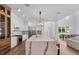 Bright kitchen boasts a large island with seating, stainless steel appliances, and custom cabinets at 734 Terra Pl, Maitland, FL 32751
