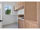 Convenient laundry room features custom cabinets, a utility sink, and stylish tile flooring at 734 Terra Pl, Maitland, FL 32751