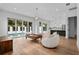 Open-concept living space with sliding glass doors that lead to the pool, white walls and wood flooring at 734 Terra Pl, Maitland, FL 32751