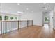 Bright and open loft space with wood floors, large windows, and modern railing, perfect for relaxation at 734 Terra Pl, Maitland, FL 32751