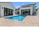 Backyard features a modern home and guest house surrounding a sparkling swimming pool with travertine pavers at 734 Terra Pl, Maitland, FL 32751