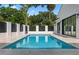 Backyard features a black and white fence surrounding a sparkling swimming pool and a beautifully landscaped yard at 734 Terra Pl, Maitland, FL 32751