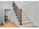 Close up view of a staircase with wood treads, metal railings, and ambient lighting underneath at 734 Terra Pl, Maitland, FL 32751