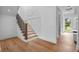Elegant staircase with wood treads, metal railings, and ambient lighting, blending design and functionality at 734 Terra Pl, Maitland, FL 32751