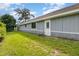 Spacious backyard features a well-kept lawn and exterior access door at 737 Tanglewood Rd, Winter Springs, FL 32708