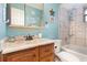 Bright bathroom featuring tile flooring, wooden vanity, and matching mirror at 737 Tanglewood Rd, Winter Springs, FL 32708