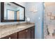 Charming blue bathroom with vanity, granite countertops, and framed mirror at 737 Tanglewood Rd, Winter Springs, FL 32708