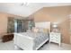 Bright bedroom with a vaulted ceiling, white furniture, and decorative curtains at 737 Tanglewood Rd, Winter Springs, FL 32708