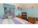 Cozy bedroom featuring a colorful bedspread and natural light from the window at 737 Tanglewood Rd, Winter Springs, FL 32708