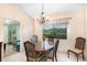 Cozy dining room featuring a wooden table, decorative chandelier, and a window view at 737 Tanglewood Rd, Winter Springs, FL 32708