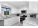 Modern kitchen featuring sleek countertops, stainless steel appliances, and ample natural light from a window at 737 Tanglewood Rd, Winter Springs, FL 32708