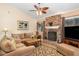 Inviting living room featuring a cozy brick fireplace and plush seating, perfect for relaxing and entertaining at 737 Tanglewood Rd, Winter Springs, FL 32708