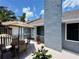 Charming patio with outdoor seating and an umbrella for shade at 737 Tanglewood Rd, Winter Springs, FL 32708