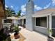 Sun-drenched patio featuring a charming table set and meticulously maintained potted plants at 737 Tanglewood Rd, Winter Springs, FL 32708