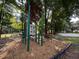 Outdoor workout station with various exercise equipment, set in a wood chip area, surrounded by mature trees at 737 Tanglewood Rd, Winter Springs, FL 32708
