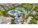 Aerial view of the waterpark with multiple slides, swimming pools, and a splash pad area at 7647 Fairfax Dr, Kissimmee, FL 34747