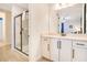Bright bathroom featuring white cabinets, a walk-in shower, and clean design at 7647 Fairfax Dr, Kissimmee, FL 34747