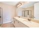 Spacious bathroom with double vanity, soaking tub, and glass-enclosed shower for a spa-like experience at 7647 Fairfax Dr, Kissimmee, FL 34747