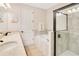 Well-lit bathroom featuring double sinks, a soaking tub, and a glass-enclosed shower at 7647 Fairfax Dr, Kissimmee, FL 34747