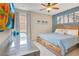 Comfortable bedroom with a queen-sized bed, blue accents, and a mounted television at 7647 Fairfax Dr, Kissimmee, FL 34747