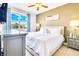 Bright bedroom with a large window, neutral tones, and stylish furnishings at 7647 Fairfax Dr, Kissimmee, FL 34747