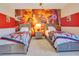 themed bedroom with two beds featuring Incredibles wall decor at 7647 Fairfax Dr, Kissimmee, FL 34747