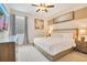 Bedroom with a queen bed, modern furniture, and soft, inviting decor at 7647 Fairfax Dr, Kissimmee, FL 34747