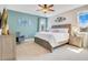 Serene bedroom featuring a king-sized bed, soft color palette, and bright natural light at 7647 Fairfax Dr, Kissimmee, FL 34747